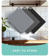 Non-slip flexible cutting mat set, thin dishwasher-safe chopping boards hanging in a modern kitchen.