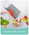 Flexible, non-slip chopping mat for easy pouring of sliced vegetables into a salad bowl. Dishwasher-safe kitchen board.