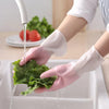 Silicone cut-resistant dishwashing gloves and cleaning scrubbers washing lettuce under a kitchen faucet.
