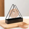 Iron mosquito coil holder with tray, featuring a black triangular metal stand for burning incense coils outdoors.