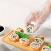 100-piece disposable food prep gloves used for sanitary sushi handling on a wooden serving tray.
