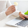 100-Piece Disposable Food Prep Gloves worn while eating snacks and working on a laptop for clean, mess-free use.