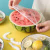 100pcs food-grade stretchable plastic wrap covering a watermelon, bowls, and fruit for freshness and anti-dust storage.