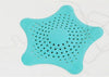 Silicone star sink strainer and hair catcher for shower drains in teal, effectively trapping loose hair.