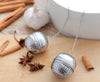 Stainless steel tea infuser mesh filter ball with hanging hook for steeping loose leaf tea, herbs, and spices.