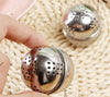 Stainless steel mesh tea infuser ball with hanging hook for steeping loose leaf tea, spices, and herbs.