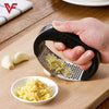 Stainless steel manual garlic press rocker with handle for easy mincing, crushing, and chopping of garlic and ginger.