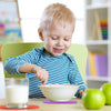 2-Piece silicone heat-resistant trivet set used as colorful non-slip coasters under a cereal bowl and glass of milk.