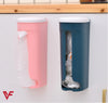 Wall-mount plastic kitchen organizer and garbage bag storage dispenser in pink and blue for home shopping bag storage.