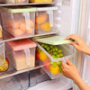 Pack of 3 plastic fridge organizer storage bins with lids and handles for kitchen fruit and vegetable organization.