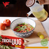 1L Measuring Oil Jug with Lid pouring oil into a bowl for salad preparation, BPA-free kitchen tool.