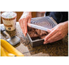6-piece reusable silicone stretch lid set sealing a square baking pan with brownies for airtight food storage.