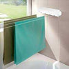 Retractable Automatic Clothesline wall-mounted for indoor drying with towels hanging over the line by a window.