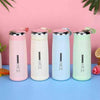 NICE Water Bottle set: Four pastel-colored stainless steel vacuum flasks with lids on a blue table.
