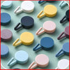 Pack of 12 creative plastic sticky hooks in assorted colors for wall storage, home organization, and hanging decor.