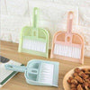 Set of mini hand brush and dustpan in pastel colors for cleaning desk crumbs and small household messes.