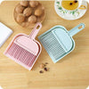 Set of mini hand brush and dustpan in pastel pink and blue for cleaning small tabletop messes and walnut debris.