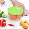 Speedy Chopper manual hand-pull food processor dicing carrots, broccoli, and peppers for quick kitchen meal prep.