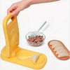 Manual plastic dumpling mold making fresh dough wrappers and filled savory dumplings for quick kitchen prep.