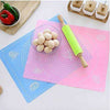 Non-stick silicone baking mat with measurement guides, featuring a rolling pin and eggs for pastry and dough prep.