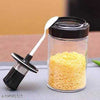 Spoon Lid Jar: Glass spice container with a built-in serving spoon and airtight black lid for kitchen storage.