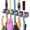 5 in 1 Mop Holder wall mount organizer with 5 slots and 6 hooks for brooms, mops, and cleaning tool storage.