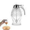 Honey Jar Dispenser with trigger handle for mess-free pouring of honey, syrup, or nectar into a glass container.
