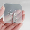 Pack of 10 adhesive single hooks, heavy-duty transparent wall hooks for damage-free hanging in home or kitchen.