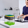 2-in-1 soap pump dispenser with sponge holder for organized kitchen countertops, holding green dish soap.