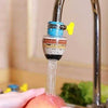 360° rotating faucet splash filter fan with multi-layer water purifier attachment washing fruit in a kitchen sink.