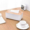 Wooden tissue box cover, rectangular handcrafted facial tissue holder with white base and bamboo wood lid on desk.