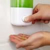 Wall-mounted liquid soap dispenser dispensing soap into hand, ideal for sleek bathroom and kitchen organization.