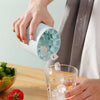 Mini Silicone Ice Bucket 2-in-1 ice cube maker dispensing ice into a glass for quick chilling.