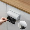 Wall-mounted garbage bag storage box and adhesive kitchen bag dispenser dispensing a black plastic trash bag.