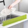 Silicone sink splash guard with suction cups acting as a waterproof splatter board for kitchen or bathroom sinks.