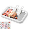 Small household yogurt frying machine and DIY ice cream maker with fruit-topped rolled ice cream and spatulas.