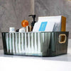 Royal Multi-Purpose Organizer: Crystal clear acrylic desktop basket holding skincare and toiletries on a vanity.