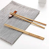 Pack of 10 pairs reusable bamboo chopsticks with non-slip texture for sushi and Asian cuisine dining.