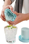 Mini Silicone Ice Bucket, 2-in-1 Ice Cube Maker and Storage Box, dispensing fresh ice cubes into a glass.