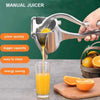 Strong Metal Hand Juicer, small manual citrus press squeezing fresh orange juice into a glass for daily kitchen use.
