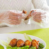 Disposable plastic gloves, pack of 100, food-safe transparent hand protection for handling food and meal preparation.