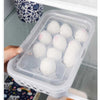 15-Grid Egg Storage Tray, a stackable refrigerator organizer with a clear lid holding fresh eggs inside the fridge.