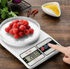 SF-400 digital kitchen weight scale measuring a bowl of fresh raspberries on a wooden table.