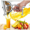 Strong metal hand juicer, a small manual citrus press for daily use, pouring fresh orange juice into a glass.