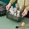 Royal Multi-Purpose Organizer: Crystal clear acrylic desktop basket holding skincare bottles and makeup accessories.