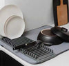 Dish Drying Mat with Rack, super absorbent kitchen draining pad with plates, cookware, and cutlery on a gray countertop.