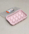 15-grid pink egg storage tray with lid, a stackable refrigerator organizer for space-saving kitchen storage.