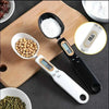 Digital Measuring Spoon Scale 500g/0.1g high precision electronic kitchen scale measuring food ingredients on wood board.
