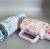 Stainless Steel Flower Design Tumbler, vacuum insulated car mug with lid, featuring floral patterns and carry handle.