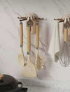 5-Claw Retractable Wall Hook used for organizing kitchen utensils and towels on a marble-style kitchen wall.